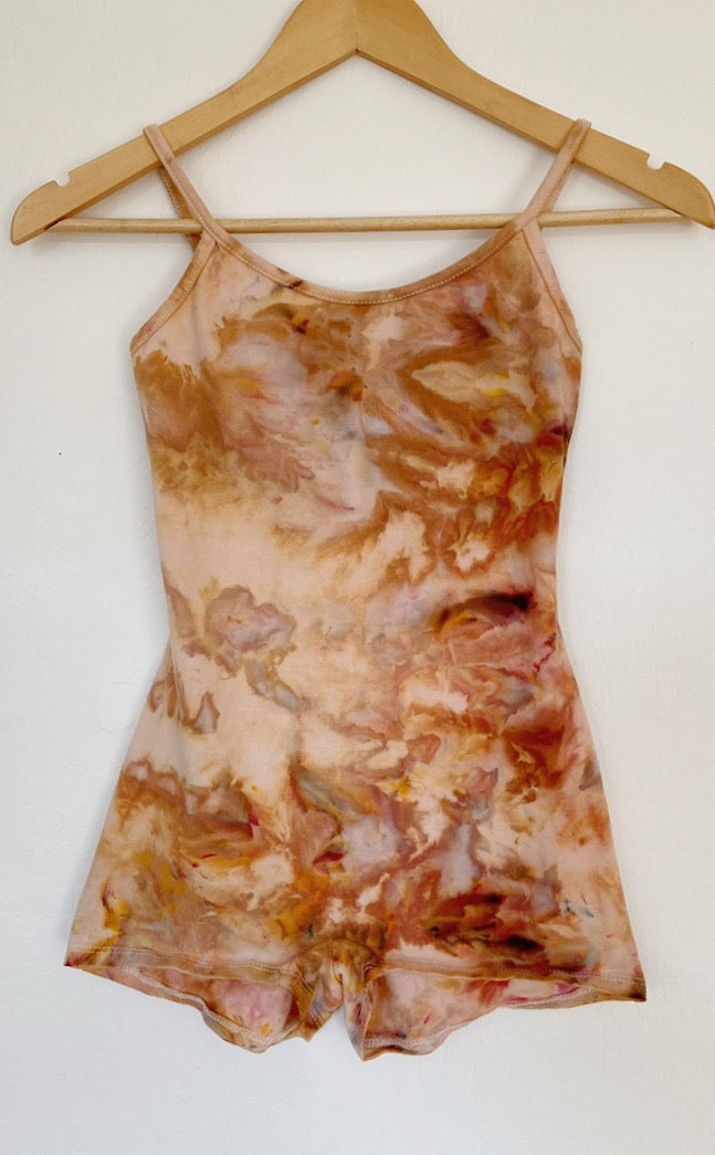 A Tie Dye romper in desert sunset tones