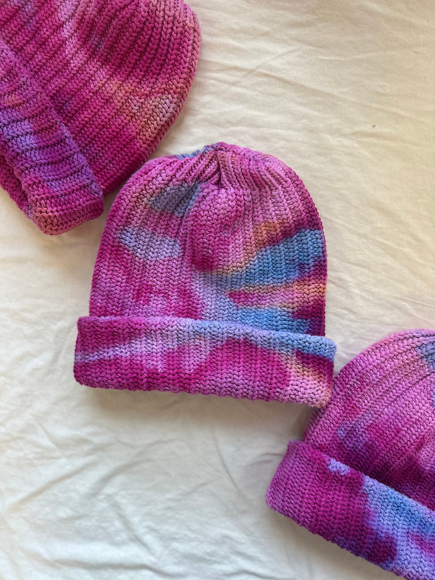 pink tie dye chunky knit beanie on white cloth