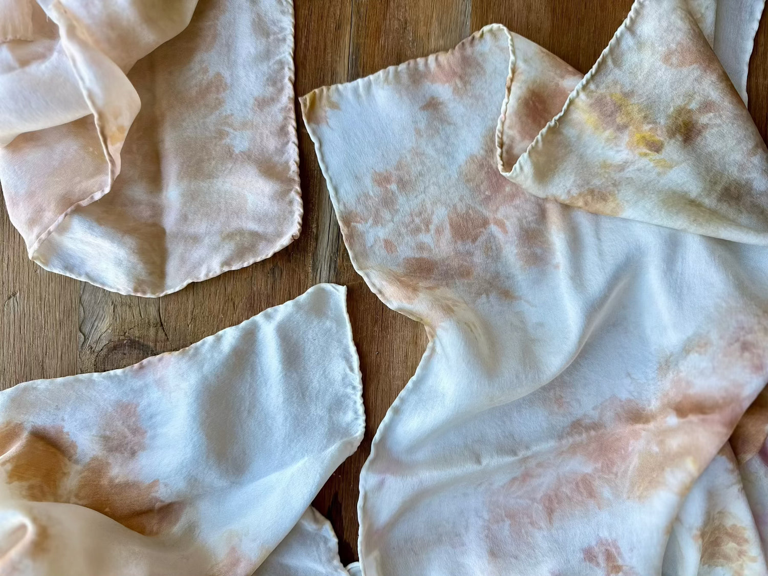 Hand dyed silk scarf draping on wood table