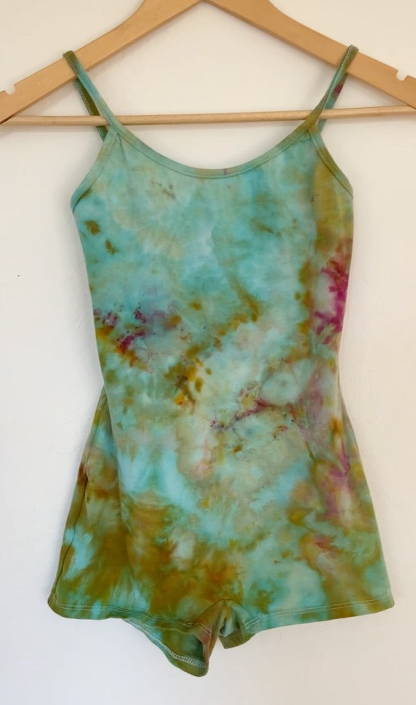 a tie dye romper in turquoise, pink and ochre tones.